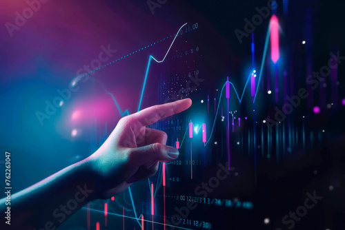 Close up of hand pointing at glowing business chart on dark blue background. Stock, market and trade concept.