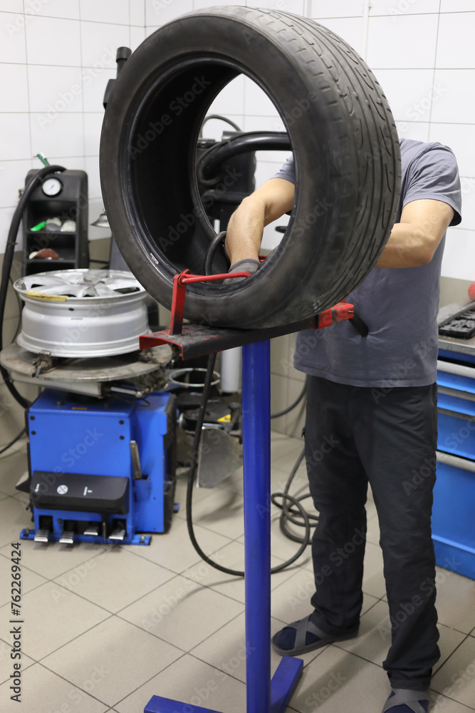The automaker makes pressure test and repairs the car tire in the workshop