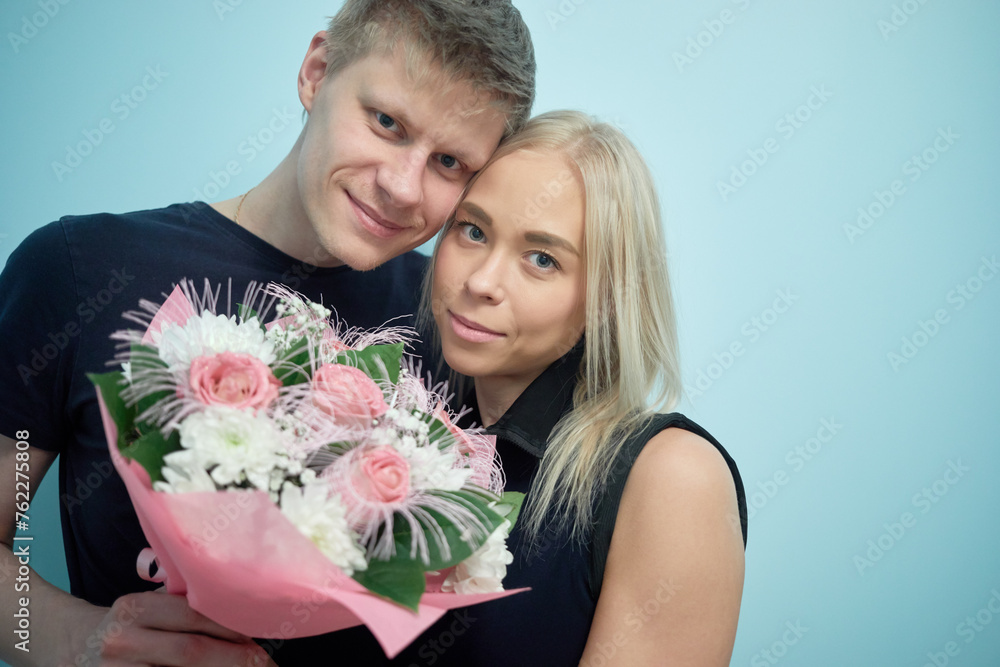 Portrait of young couple with bunch of flowers. Portrait of young couple with bunch of flowers.