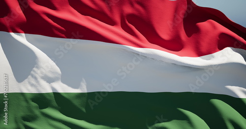 Close-up of the national flag of Hungary flutters in the wind on a sunny day