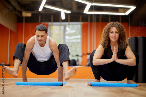 Wallpaper Mural Man and woman in yoga positions on mats in gym. Torontodigital.ca