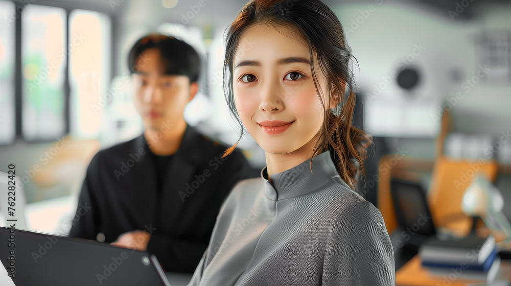 pretty asian young woman working with laptop in modern office pretty asian young woman working with laptop in modern office