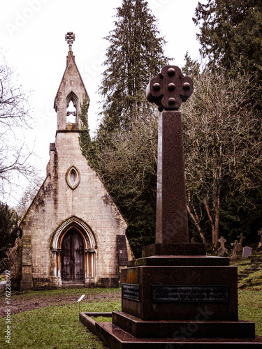Old stone church with monument in foreground