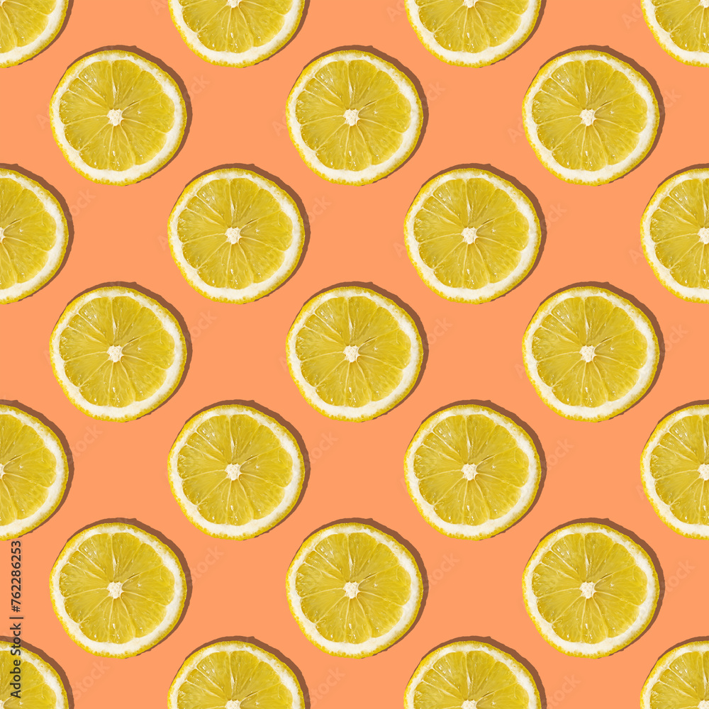 Uniform pattern of lemon slices with shadow on a peach trendy background. Flat layout