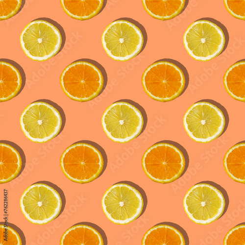 Uniform pattern of orange and lemon slices with shadow on a peach trendy background. Flat layout