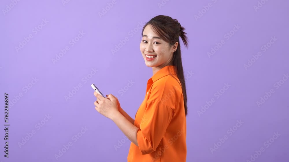 Asian woman using phone to text with friends
Asian woman using phone to text with friends