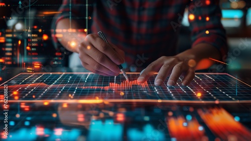 Hand of stock broker pointing with a pen at a financial graph chart stock trading analyze datum, business investment concept