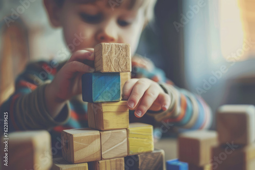 child plays with wood construction blocks
