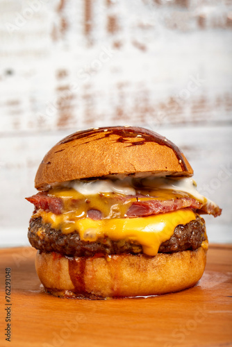 Hamburgers with cheddar cheese and special sauce on a wooden background. Close up