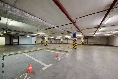 Fototapeta Naklejka Na Ścianę i Meble -  Underground parking with empty parking places.