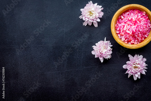 aroma therapy with pink flower fragrance and spa salt on dark background top view space for text