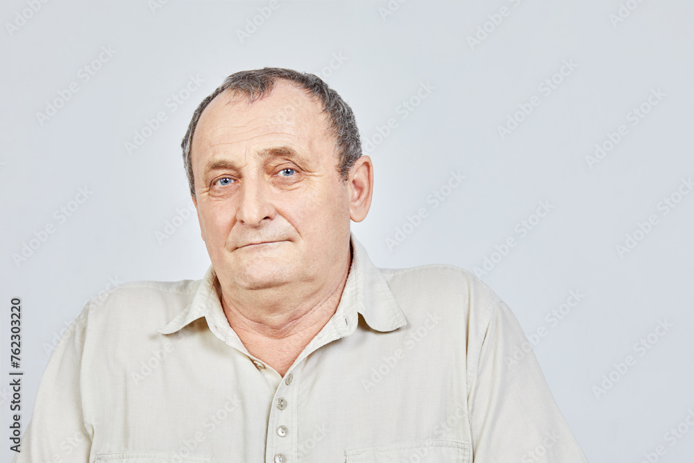 Shoulder portrait of elderly man in studio. Shoulder portrait of elderly man in studio.