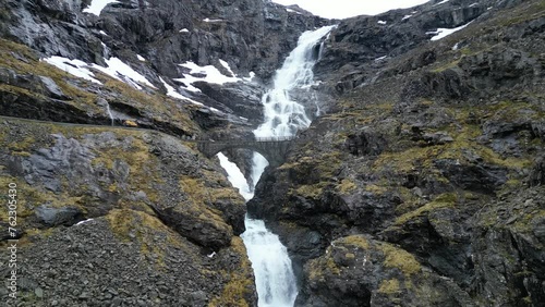The scenic Trollstigen zigzag road and Stigfossen waterfall in Isterdalen valley, Rauma, Norway photo