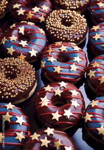 Still life of red white and blue frosted donuts with gold sprinkles.