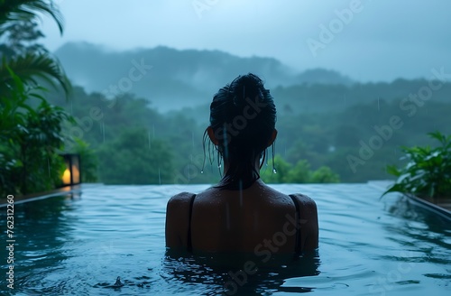 Interview Amidst the Storm: Woman in Outdoor Pool During Rain, a Nature-Inspired Scene © fahad