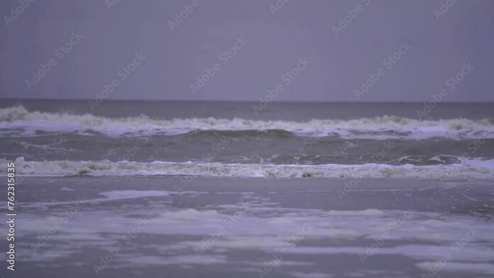 The North Sea swirling in cloudy weather. Big waves due to strong wind. Dangerous weather conditions in slow motion The North Sea swirling in cloudy weather. Big waves due to strong wind. Dangerous weather conditions in slow motion