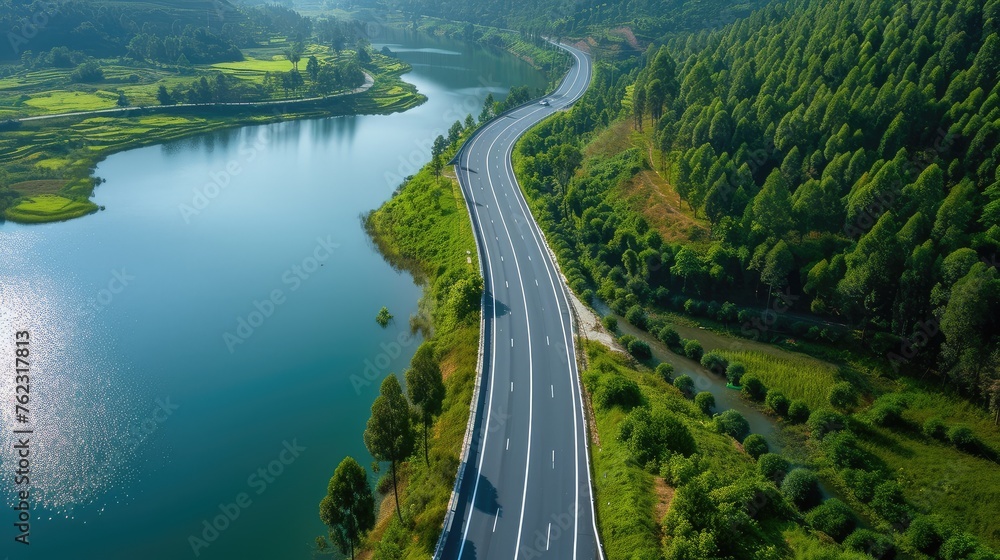 Scenic Aerial View of a Highway Along a Serene Lake