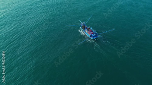 Wooden fishing boat of Vietnamese fishermen at sea, aerial view from drone. Travel and maritime theme template.
