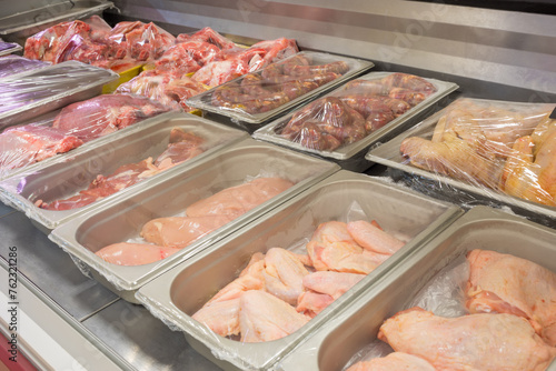 Different grades of meat in shop, Translation of text - duck thighs, chicken hearts, chicken fillet, wings of chicken