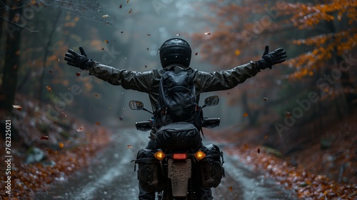 Motorcyclist embracing autumn bliss on a forest road