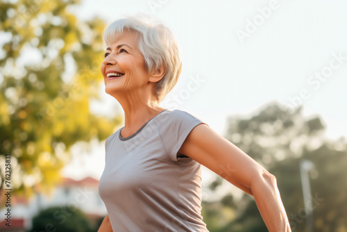 Old fit woman doing exercise outdoors