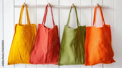 Colorful textile shopping bags hanging on a wooden hook