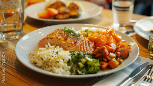 salmon rice broccoli and sweet potato in a restaurant meal