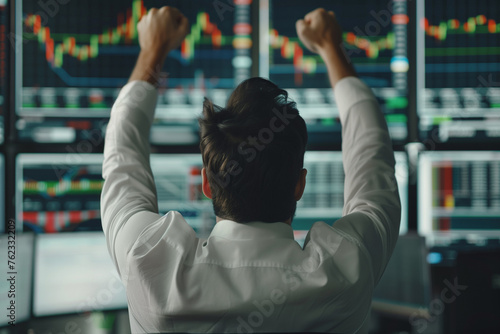 Excited Businessman Raises Hands and Punches Air while Celebrating Successful Deal. Stock Exchange Manager Happy After Investment Day. Broker in White Shirt Wins a Profitable Contract. Back View