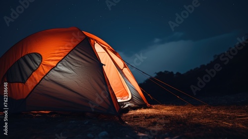 A tent illuminated in the darkness, perfect for camping or outdoor adventure concepts