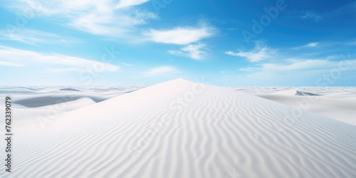 A serene white sand dune under a clear blue sky. Perfect for travel websites