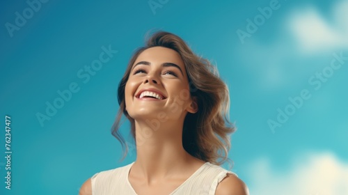 A woman smiling with a blue sky in the background. Suitable for various concepts