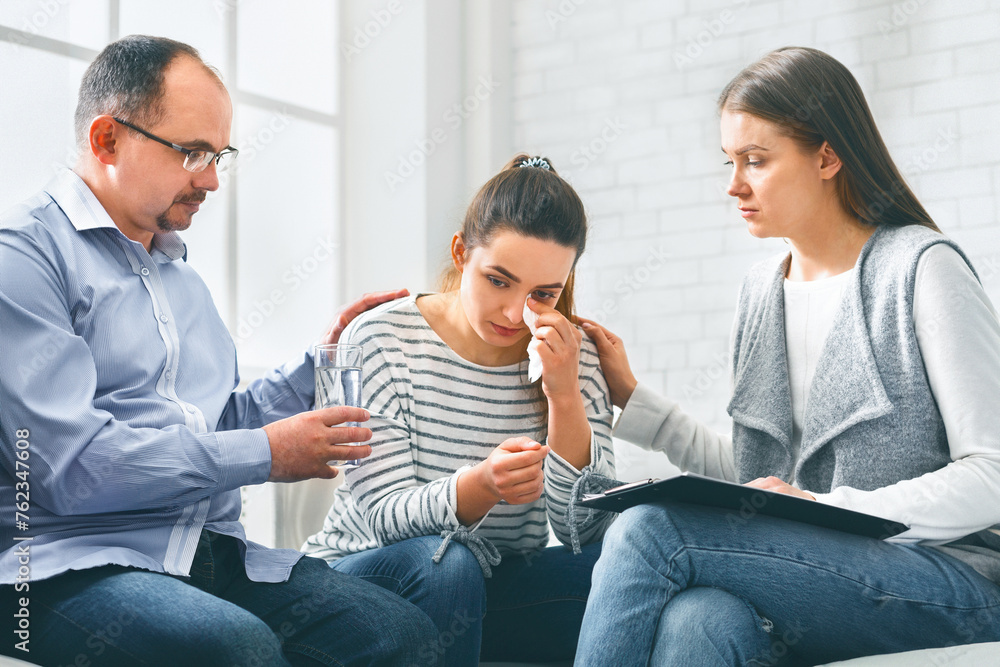 Fototapeta premium Understanding people calming crying woman during group session meeting in rehab