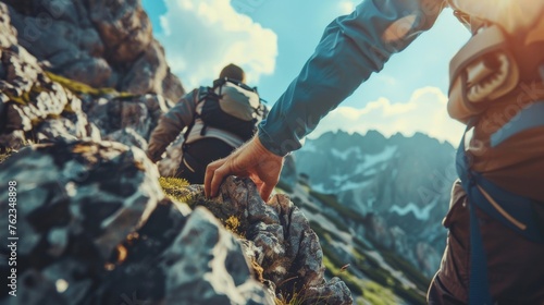 Teamwork, cohesion, together, togetherness success busniess concept - Outdoor adventure climber, extreme sport background - Close up man and woman, holding hands, climbing on a rock in the mountains