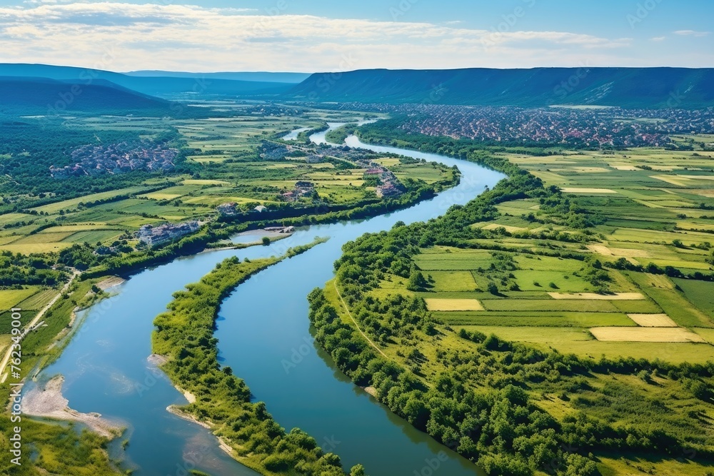 Scenic view of a river flowing through a lush green valley. Perfect for nature and landscape concepts Scenic view of a river flowing through a lush green valley. Perfect for nature and landscape concepts