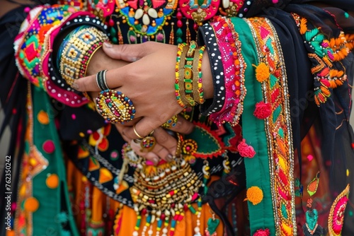 A detailed view of a persons hands adorned with beautiful bracelets, showcasing intricate details and craftsmanship