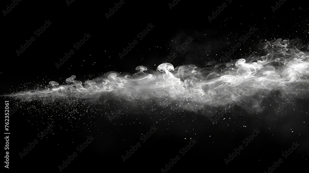 Against a black background, smoke is seen