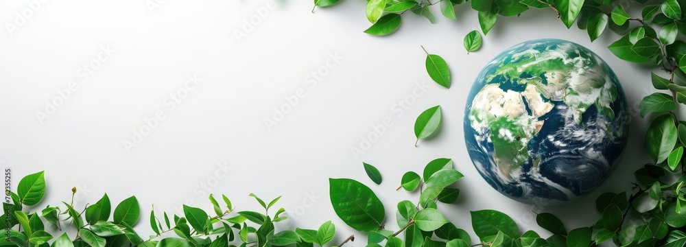 Eco concept with glass globe and green leaves on bokeh background Eco concept with glass globe and green leaves on bokeh background