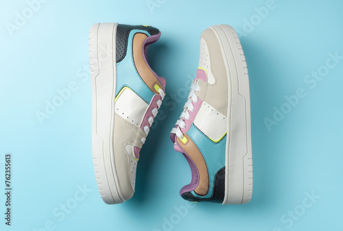 Colorful sneakers on a blue background. Flat lay, top view