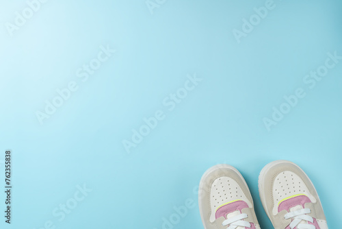 Colorful sneakers on a blue background. Space for text