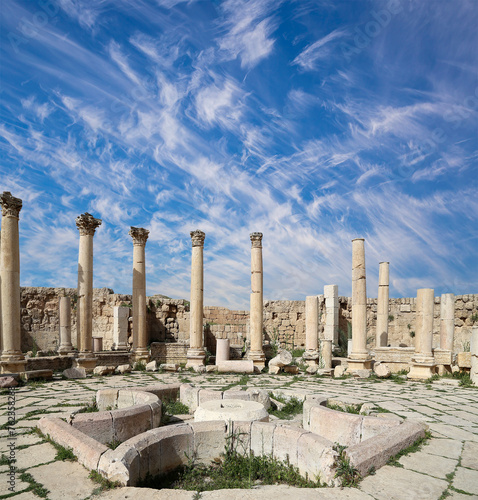 Roman ruins (against the background of a beautiful sky with clouds) in the Jordanian city of Jerash (Gerasa of Antiquity), capital and largest city of Jerash Governorate, Jordan #762358288