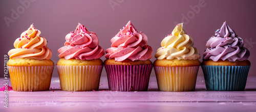 Purple-pink cupcakes with buttercream frosting. Panoramic image.