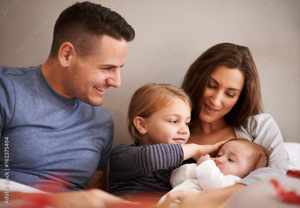 Home, family and parents with baby, kids and bonding together with happiness and care in the morning. Bedroom, mother and father with children and holding infant with comfort, smile and weekend break