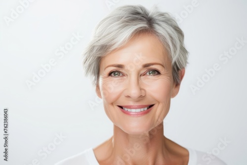 Portrait of a happy woman who has undergone blepharoplasty isolated on white background photo