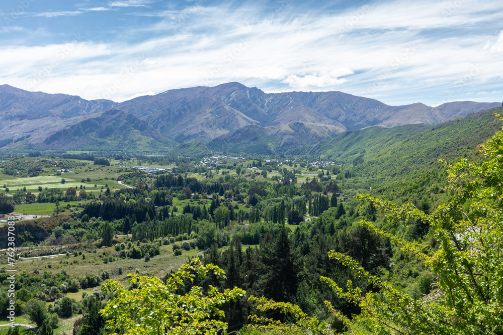 Obraz premium View from the Crown range looking over the Wakatipu Basin, a plain surrounded by mountains in the Queenstown Lakes District on the southern South Island of New Zealand.