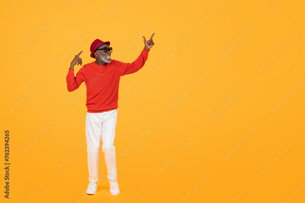 Stylish senior black man in a red sweater and hat, with sunglasses on Stylish senior black man in a red sweater and hat, with sunglasses on