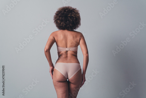 Unretouched photo of woman stand back view feel comfortable esteem body with imperfection © deagreez