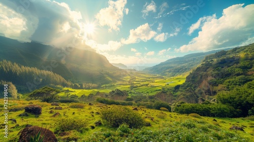 A lush green valley surrounded by towering mountains under a cloudy sky