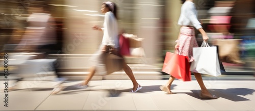 Blurred view of woman with shopping bags.