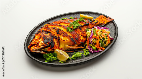 Tandoori Pomfret Fish with Lemon Mint Salad on Stone Plate, White Background photo