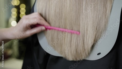 close-up of cutting ends of dry hair in a beauty salon. beautiful long blond long hair being cut with scissors professional haircut
